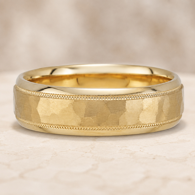 classic retro looking men's wedding band with hammered finish in yellow gold